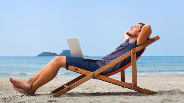 Armchair travel destinations man relaxing on beach